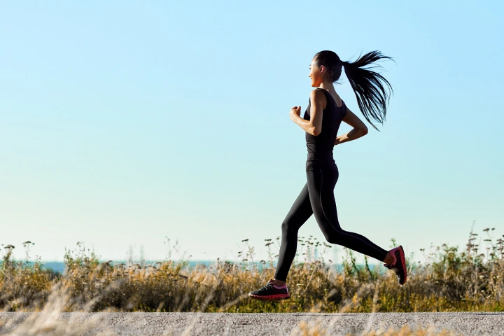 Woman running along the waterfront