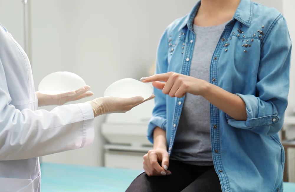 doctor showing a patient two different implants