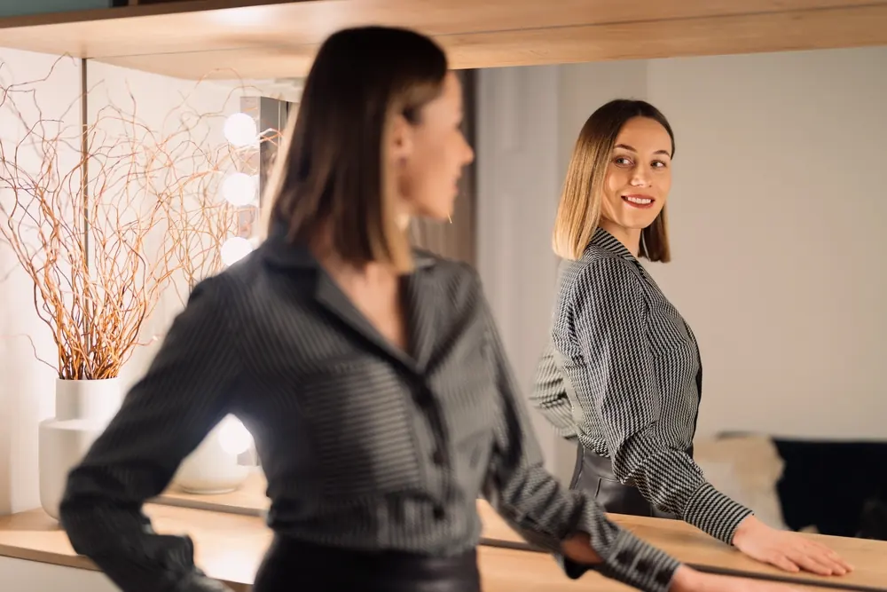 Confident woman looking in the mirror