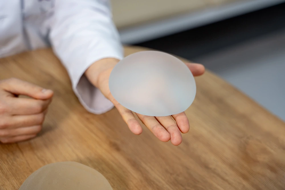 Woman holding a breast implant