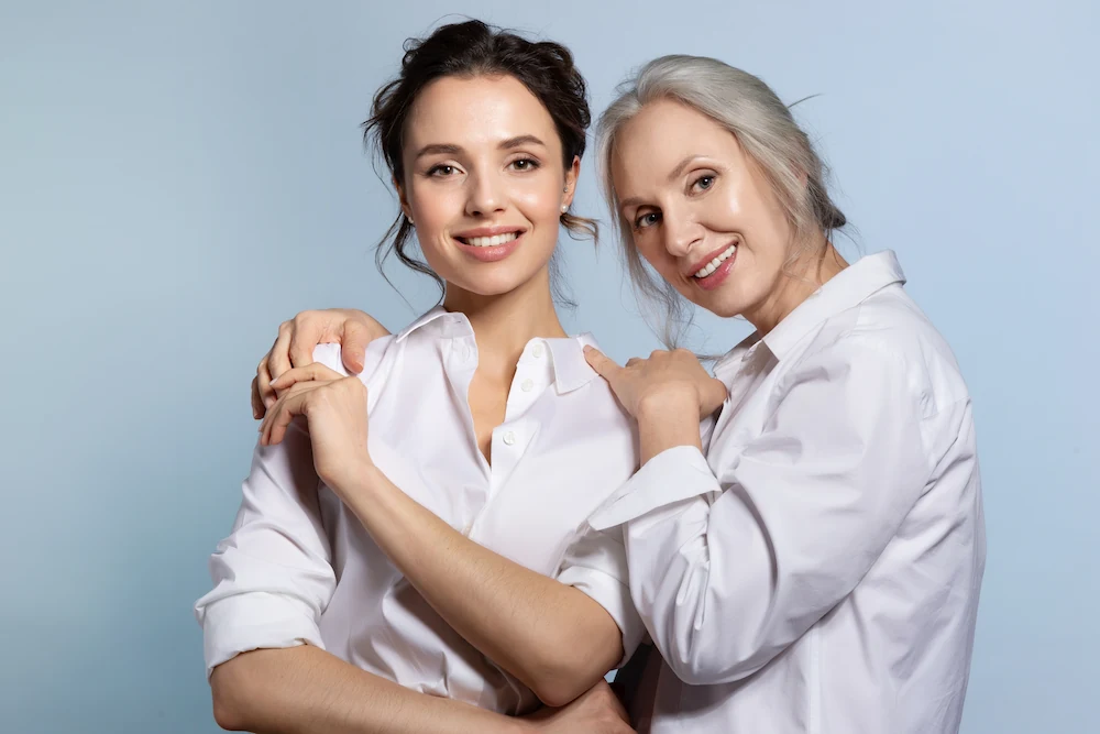 An older and younger woman standing next to each other